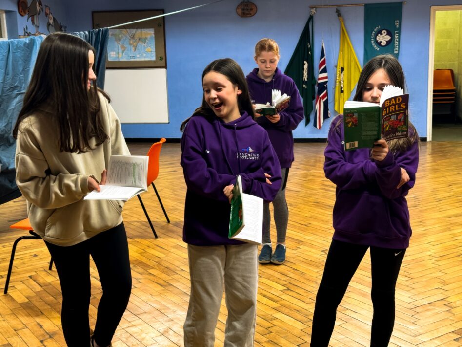 Child actors laughing and rehearsing for a play